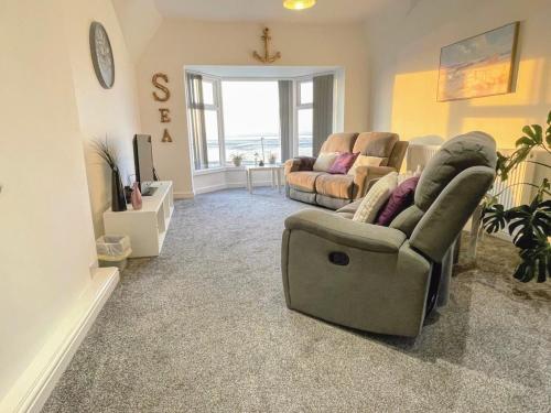 a living room with two couches and a tv at Top Floor Apt Promenade Sea Views Sleeps 6 Shore Vibes in Morecambe