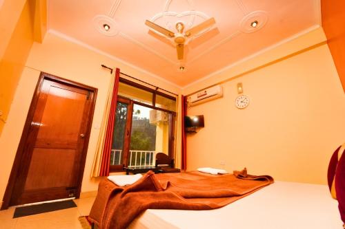 a bedroom with a bed with a cat laying on it at Shivalik River Retreat in Almora