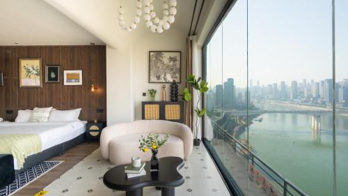 a hotel room with a bed and a large window at 重庆大野江景民宿 in Chongqing