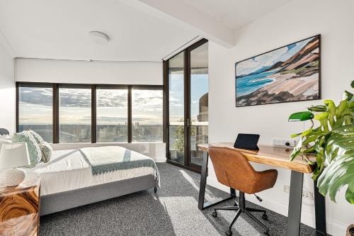 a bedroom with a bed and a desk and windows at 'The Australia St-ar' 2x King beds in Sydney