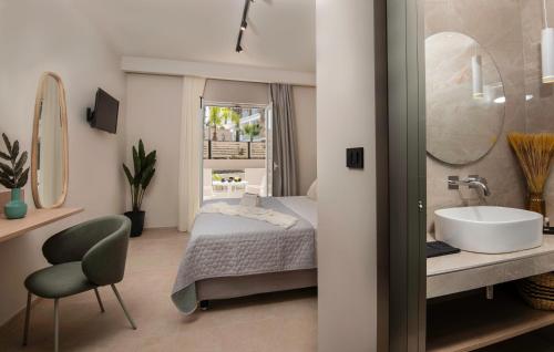 a bathroom with a bed and a sink and a mirror at Nikos & Maria Studios II in Laganas