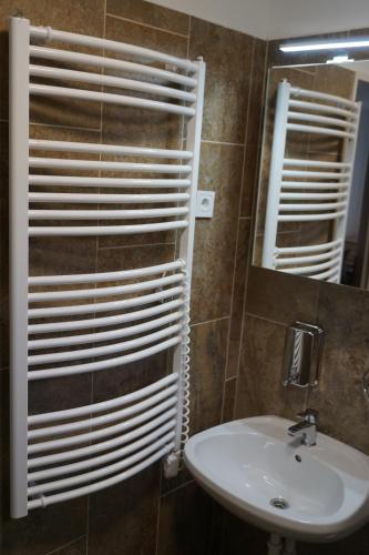 a bathroom with a sink and a mirror at Május 1 Vendégház - Torony in Torony