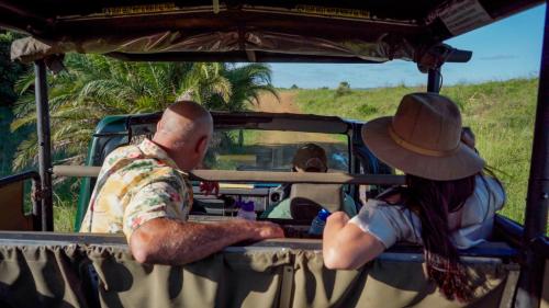 a man and a woman sitting in the back of a vehicle at Luxury Tented Village @ Urban Glamping in St Lucia