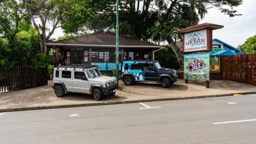 two toy jeeps parked in front of a building at Luxury Tented Village @ Urban Glamping in St Lucia