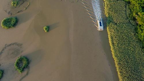 an aerial view of the ocean with a boat at Luxury Tented Village @ Urban Glamping in St Lucia