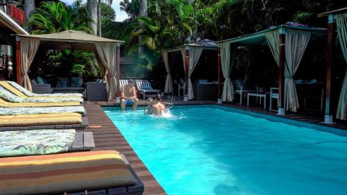 two children playing in a swimming pool at a resort at Luxury Tented Village @ Urban Glamping in St Lucia