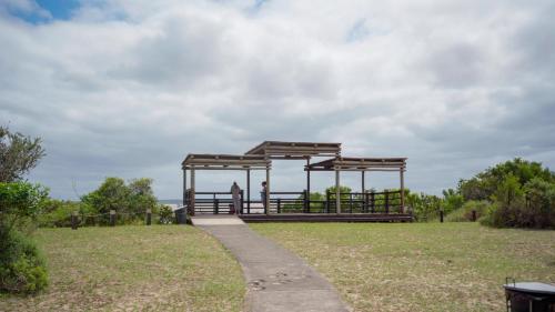 a person standing under a pavilion in a park at Luxury Tented Village @ Urban Glamping in St Lucia