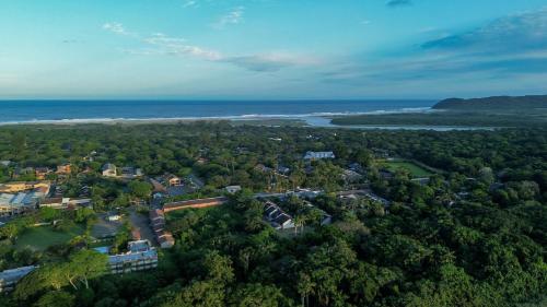 an aerial view of a town with trees and the ocean at Luxury Tented Village @ Urban Glamping in St Lucia