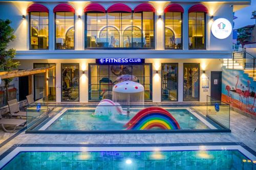 a pool with a rainbow in the middle of a building at Club Big Blue Suit Hotel - All Inclusive Plus in Alanya