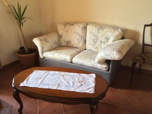 a living room with a couch and a coffee table at Ca di Voi in Calizzano