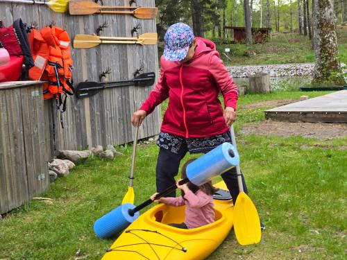 a young girl is playing in a kayak at Norrqvarn Hotel & Resort by Vänerport in Lyrestad