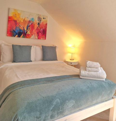 a bedroom with a bed with towels on it at Upper Rock Brighton – Guest House in Brighton & Hove