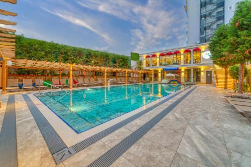 a large swimming pool in the middle of a building at Club Big Blue Suit Hotel - All Inclusive Plus in Alanya