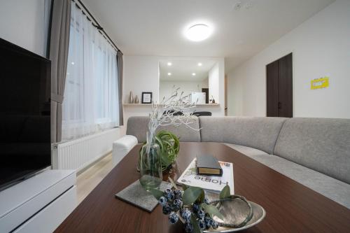 a living room with a couch and a table at Lumiere Enclave in Sapporo