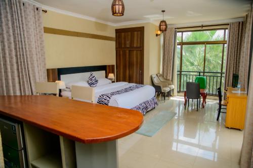a hotel room with a bed and a table at Quality Inn Hotel Kigali in Kigali