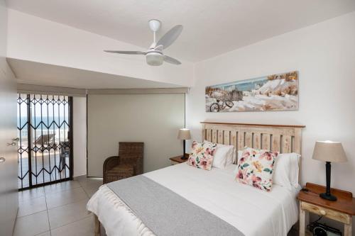 a bedroom with a bed and a ceiling fan at Le Roc 10 in Ballito