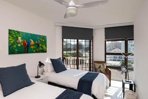 a bedroom with two beds and a window at Le Roc 10 in Ballito