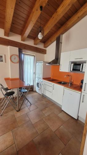 a kitchen with a table and a sink and a table at Hotel y Apartamentos Sur de la Bahía in Elechas