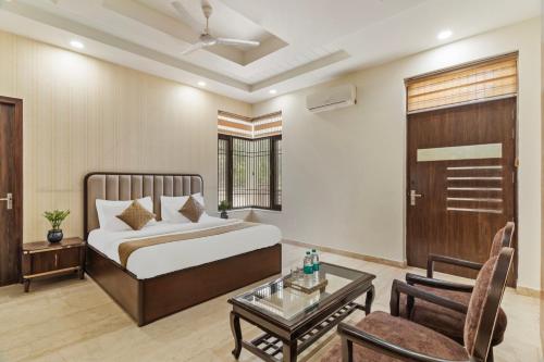 a bedroom with a bed and a living room at MIRANDA by AKAMA HOMES in Noida