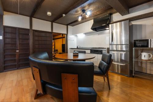 a kitchen with a table and chairs in a room at Shiki Homes HARU in Kyoto