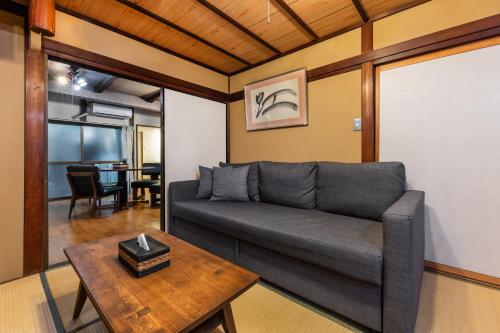 a living room with a couch and a table at Shiki Homes HARU in Kyoto