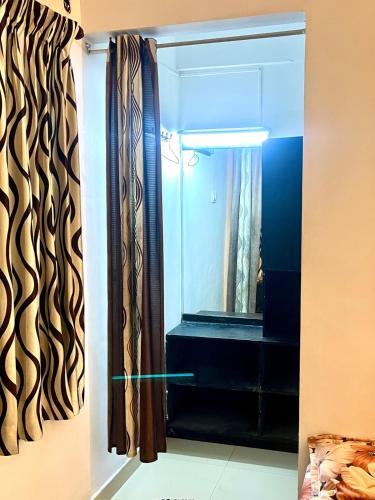 a bathroom with a shower and a mirror at GlenBrook HomeStay in Munnar