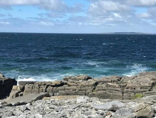a view of the ocean from a rocky beach at Luxury 4 bedroom lodge in Doolin in Doolin