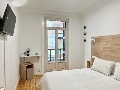 En eller flere senge i et værelse på Pensión Miramar