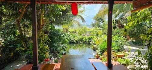 a view of a pond from the porch of a house at Khách sạn 25 tháng 12 - Tánh Linh in Tánh Linh