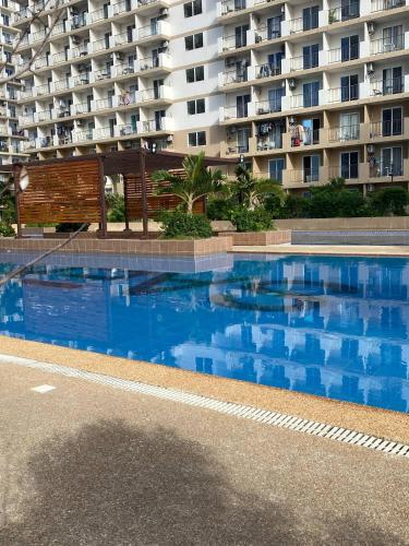 a large swimming pool in front of a large building at Saekyung Condo in Lapu Lapu City