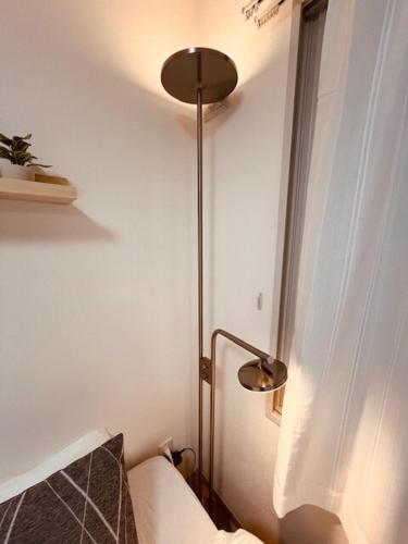 a bedroom with a lamp and a bed in a room at Raffine103 in Sapporo