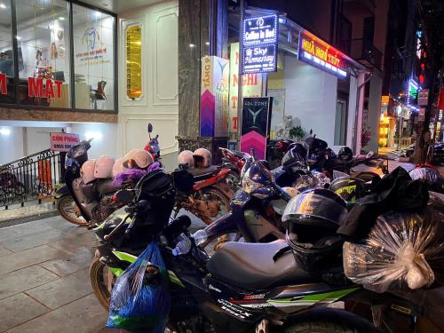 a group of motorcycles parked on a street at night at Sky Hotel & Homestay Ha Giang in Ha Giang