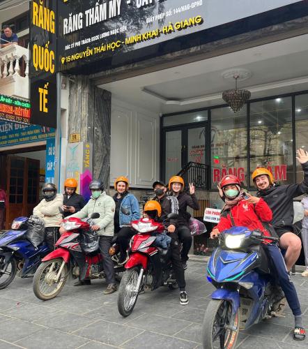 a group of people on motorcycles parked in front of a building at Sky Hotel & Homestay Ha Giang in Ha Giang