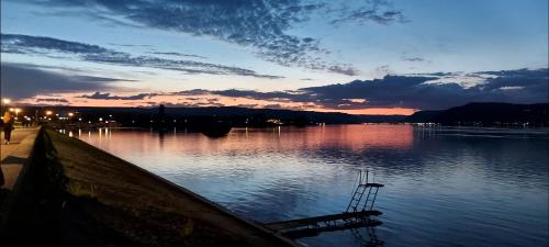 a body of water with a sunset in the background at Apartman SPLENDID in Kladovo
