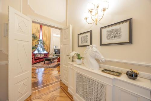 a hallway with a white horse statue on a counter at Palazzo Monga Boutique Guesthouse in Verona