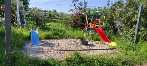 a playground with a slide in the sand at Rheinufer in Xanten