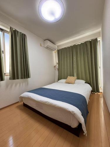 a bedroom with a large bed in a room at Comfy House Namba in Osaka