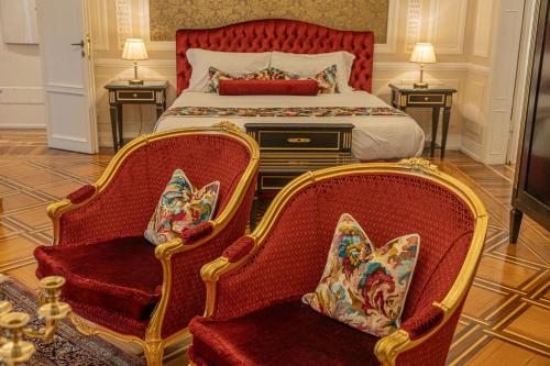 a bedroom with two chairs and a bed at Palazzo Monga Boutique Guesthouse in Verona