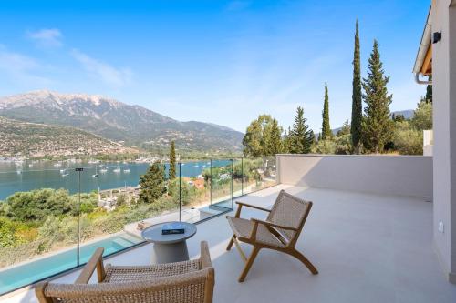 a balcony with a view of the water and mountains at Villa Olea in Yenion