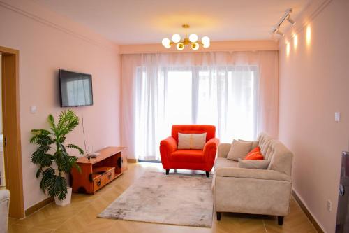 een woonkamer met een bank en een stoel bij Luxe Homes by cassie in Nairobi
