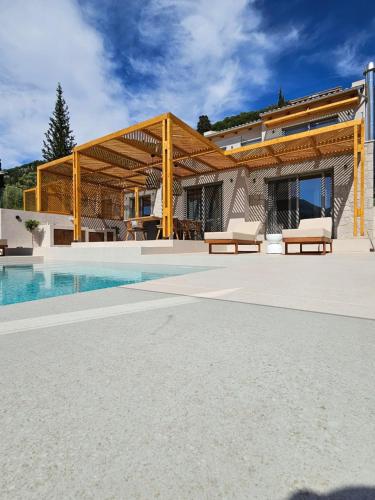 a house with a swimming pool next to a building at Villa Olea in Yenion
