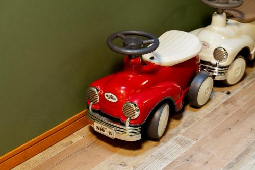 a red toy car is sitting on the floor at Fantasy Lodge in Tokyo