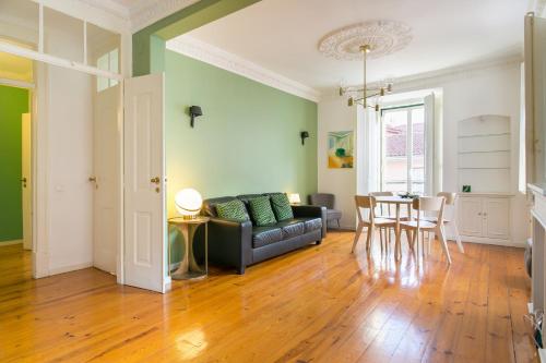 a living room with a couch and a table at Spacious, Bright and Newly Renovated 2 Bedroom Apartment, Lisbon Historical Center, Madragoa in Lisbon