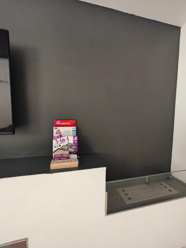 a stack of books sitting on top of a shelf at Modern Luxe Marsaskala Maisonette in Marsaskala