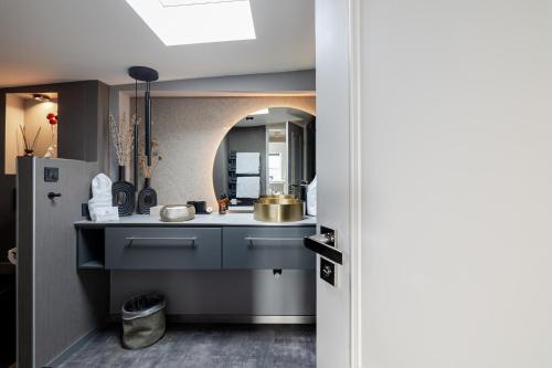 a kitchen with a sink and a refrigerator at Strönhof Kampen in Kampen