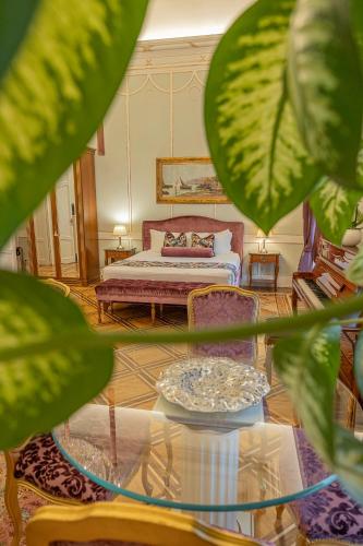 a living room with a bed and a glass table at Palazzo Monga Boutique Guesthouse in Verona