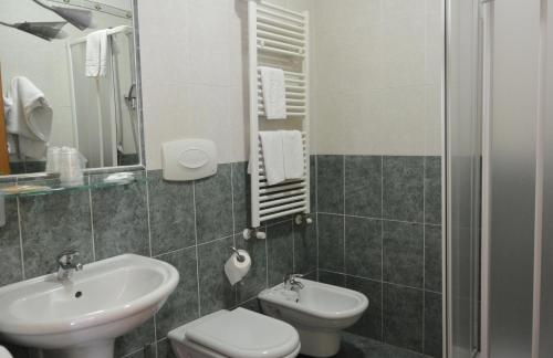 a bathroom with a sink and a toilet at Hotel Ristorante Italia in Certosa di Pavia