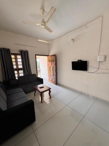 a living room with a couch and a table at Sree Shivanya Homes in Trivandrum