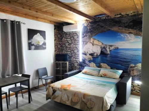 a bedroom with a view of the ocean at The square in Orosei