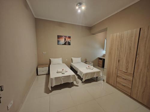 a bedroom with two beds in a room at Modern Luxe Marsaskala Maisonette in Marsaskala